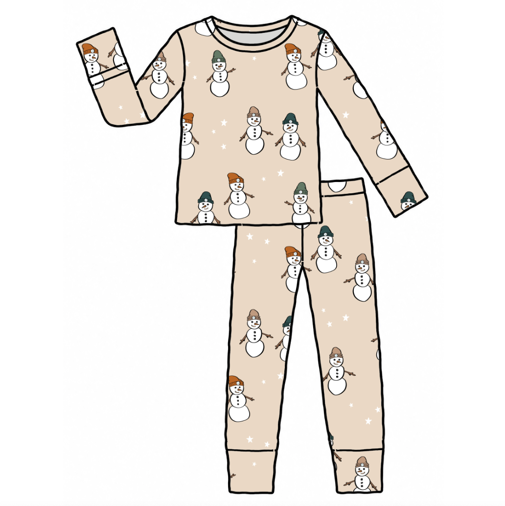 A two-piece pajama set with a long-sleeve top and matching pants, featuring an all-over print of snowmen wearing orange and green hats on a light beige background with small white stars.
