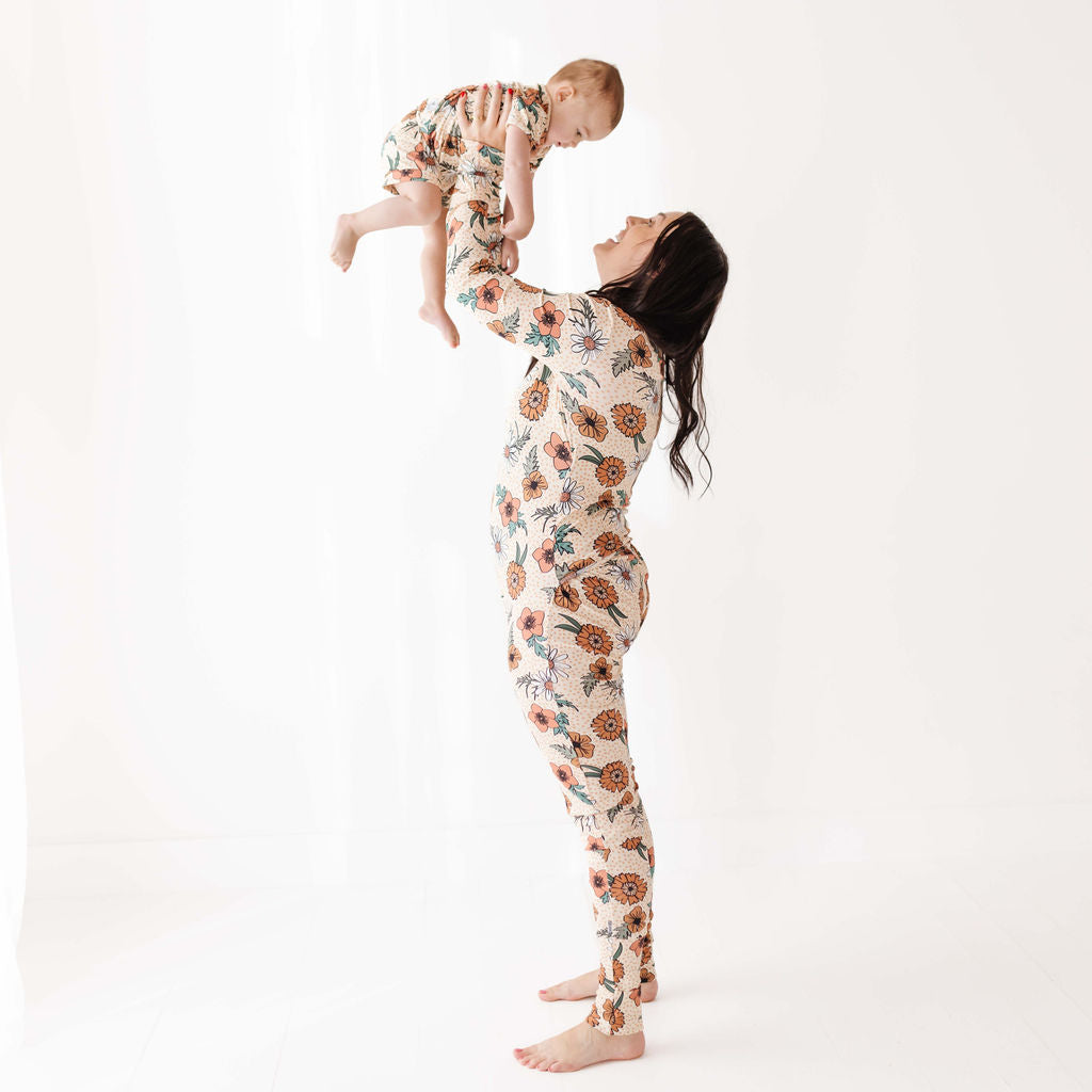 Woman and child wearing matching floral outfits on a white background