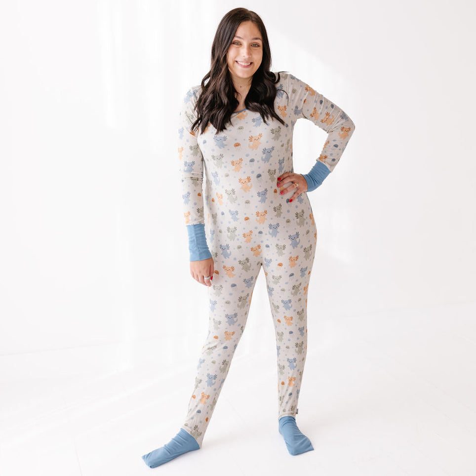Woman wearing a patterned onesie with blue socks on a white background