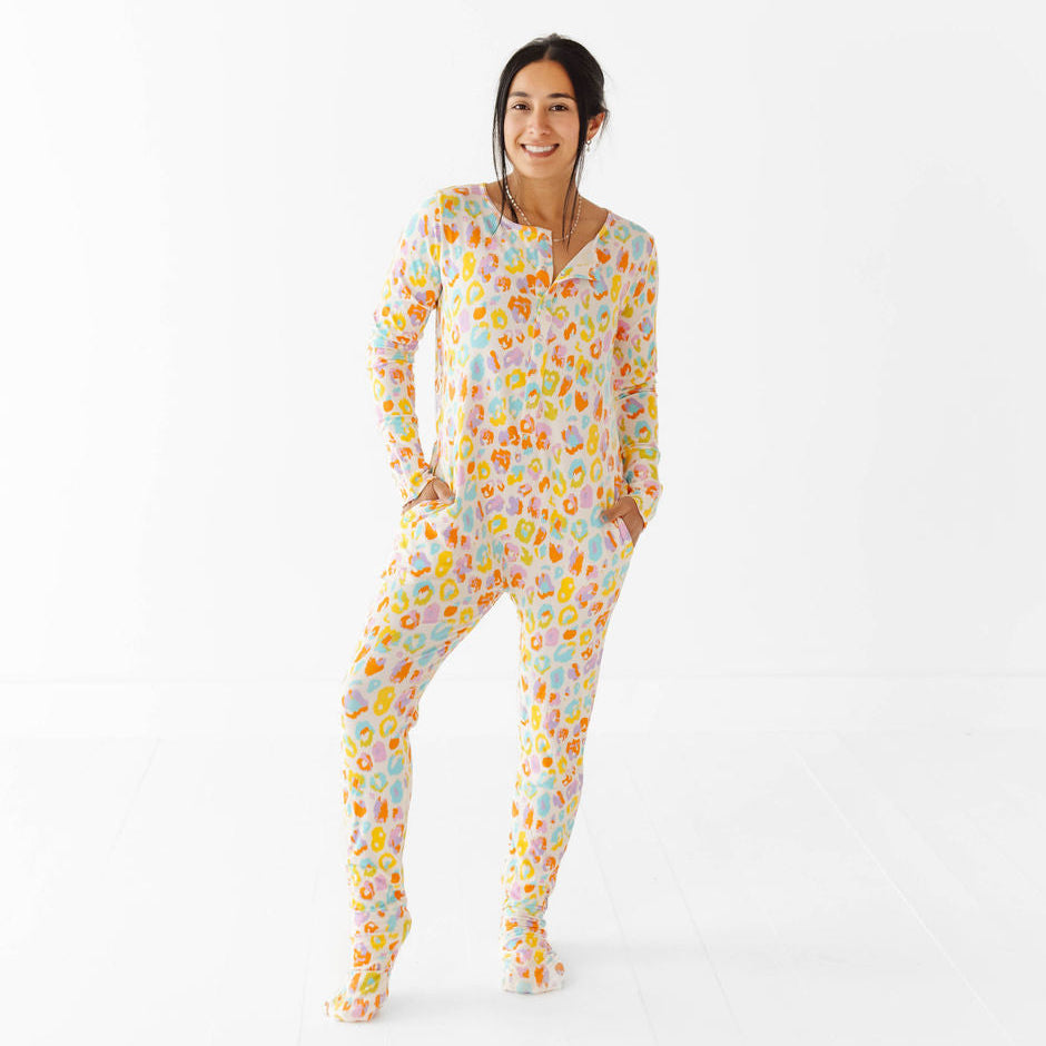 Woman wearing a colorful patterned onesie on a white background