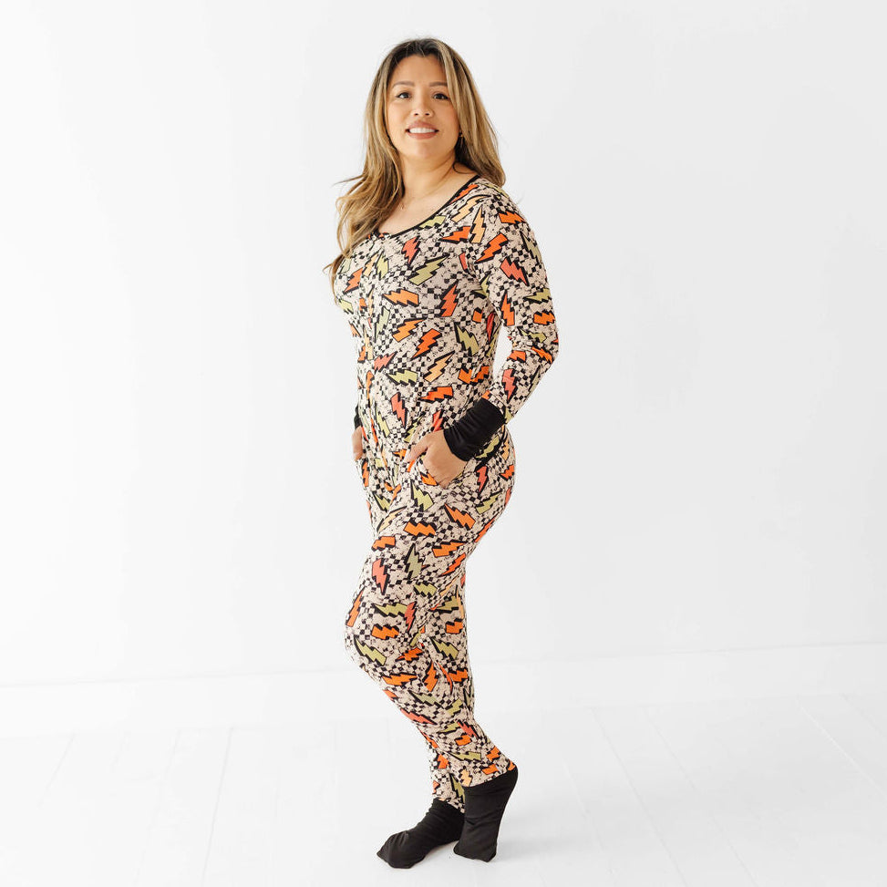 Woman wearing a patterned onesie on a white background