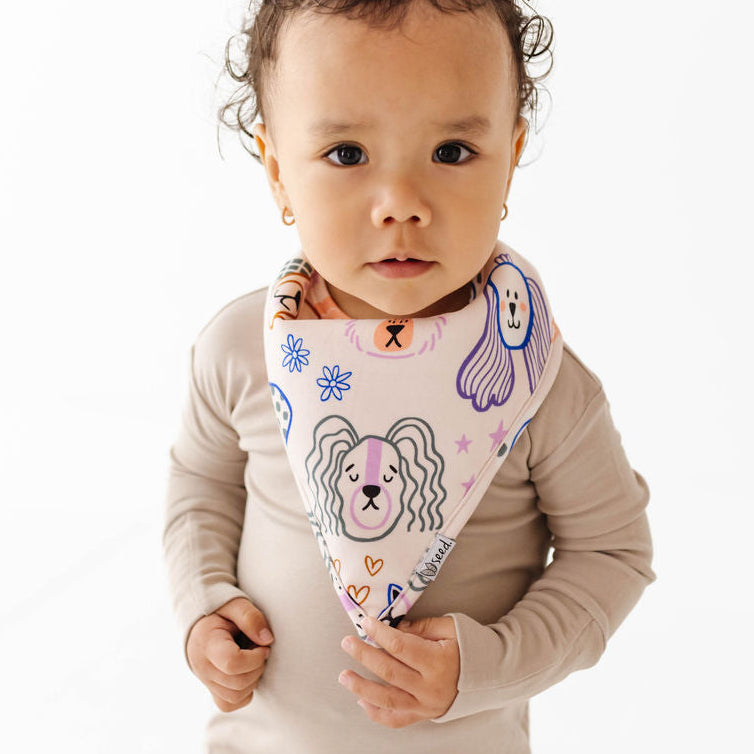 Child wearing a colorful bandana with cartoon designs on a white background