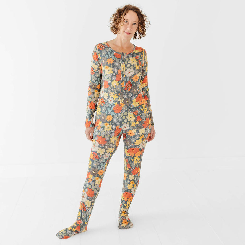Woman wearing a floral patterned onesie on a white background
