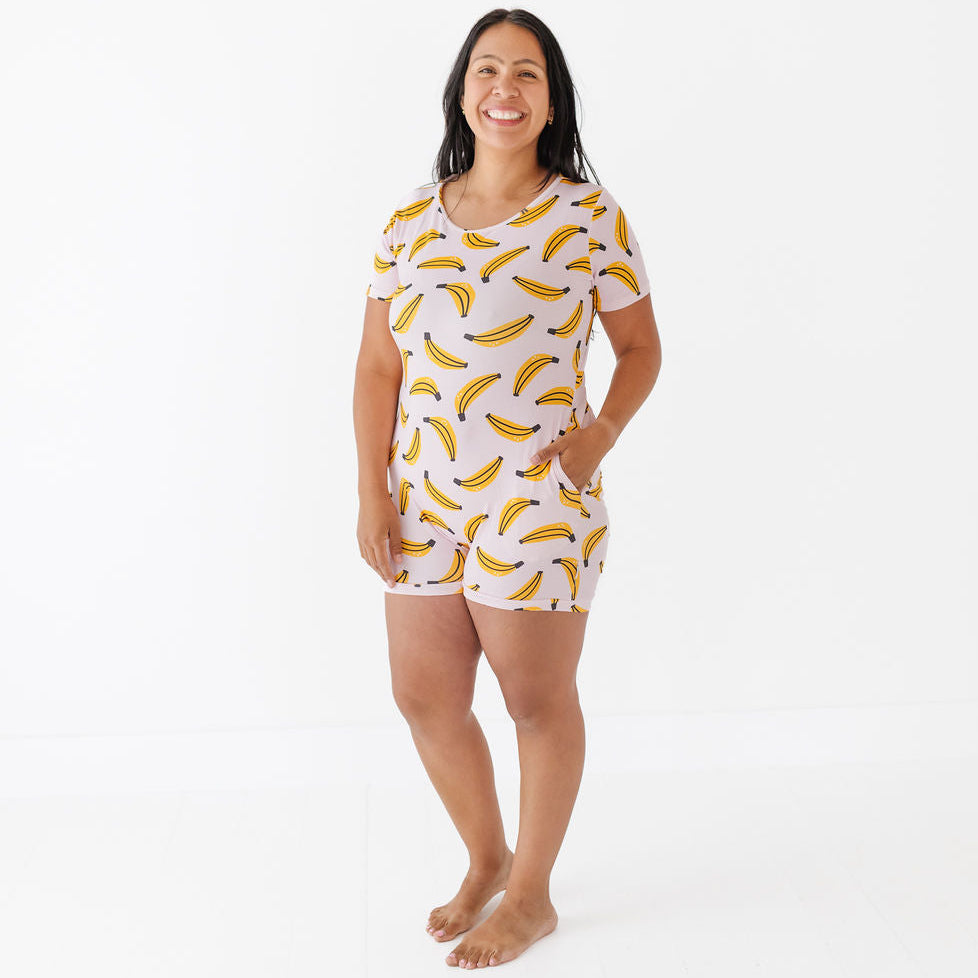 Woman wearing a banana-patterned pajama set on a white background