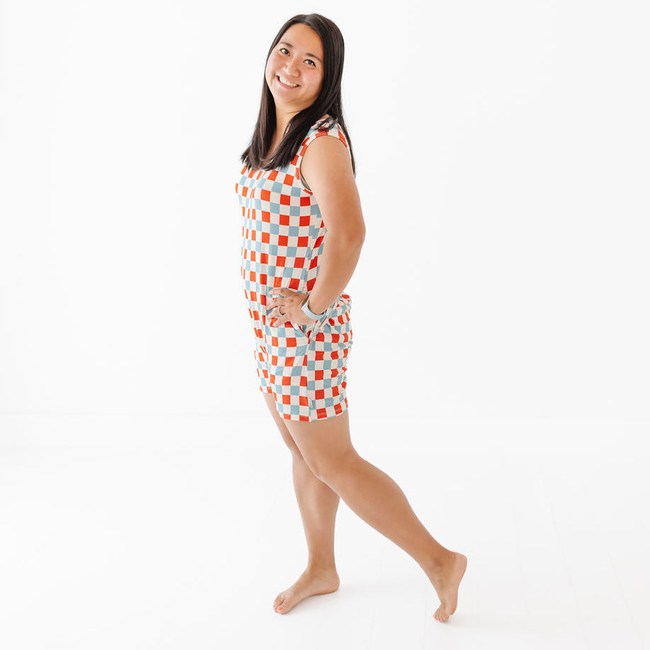 Woman wearing a red and white checkered dress on a white background