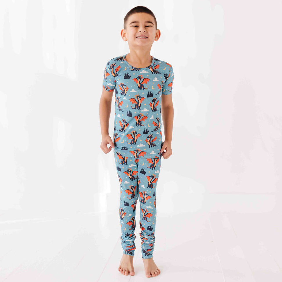 Child wearing a blue pajama set with fox pattern on a white background