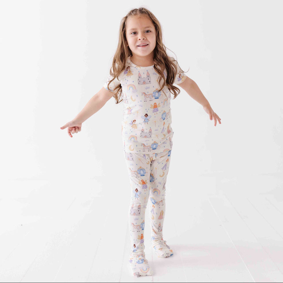 Child wearing a patterned pajama set on a white background