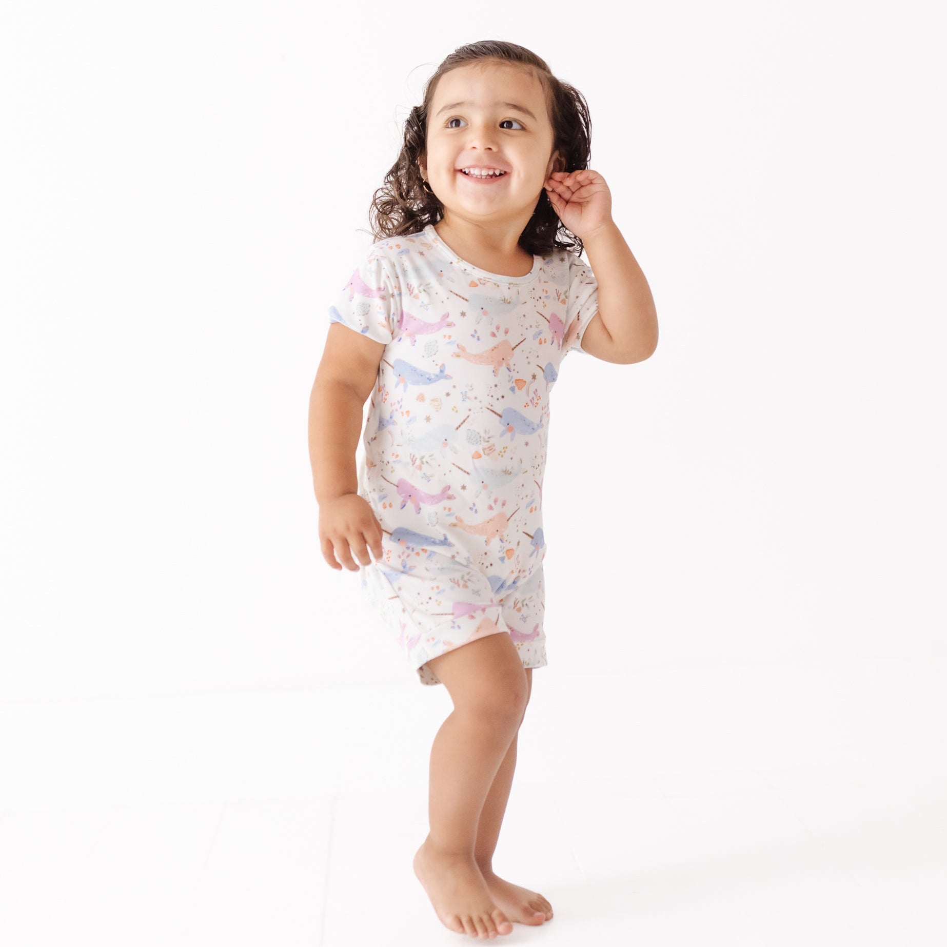 Child wearing a nightshirt with animal pattern on a white background