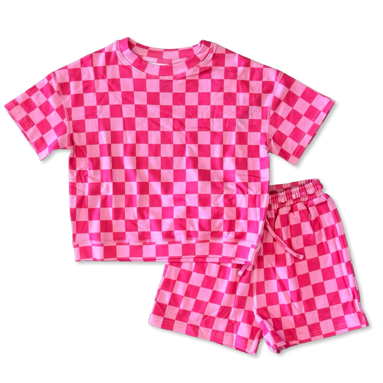 Pink and white checkered shirt and shorts set on a white background