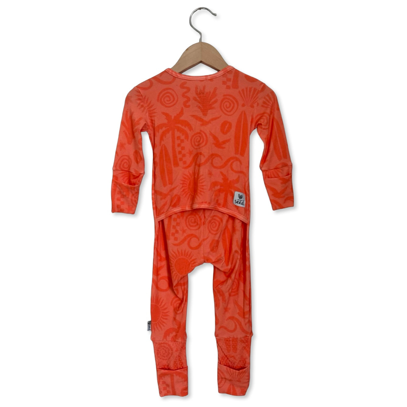 Orange children's pajama set on a hanger against a white background
