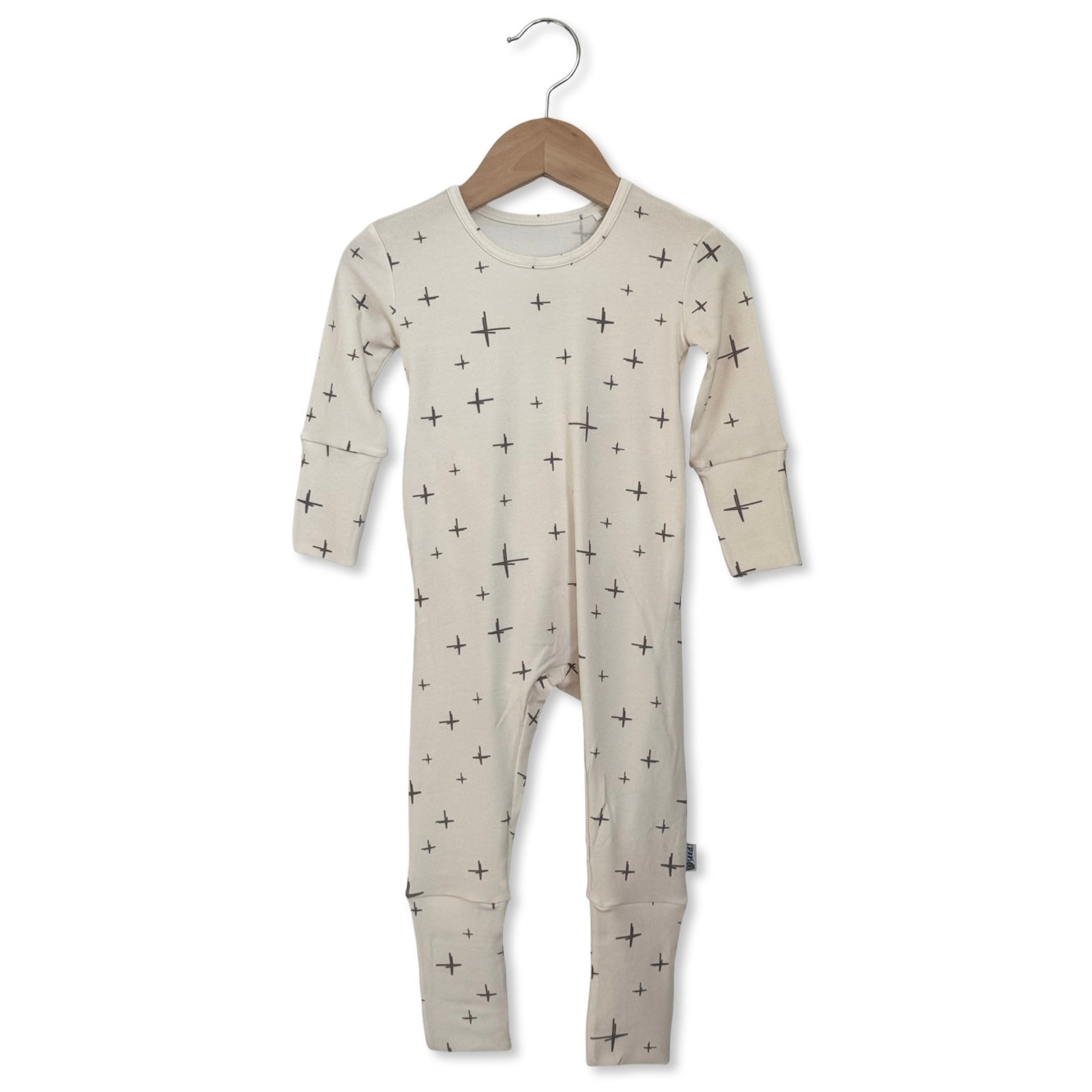 Baby onesie with star pattern on a hanger against a white background