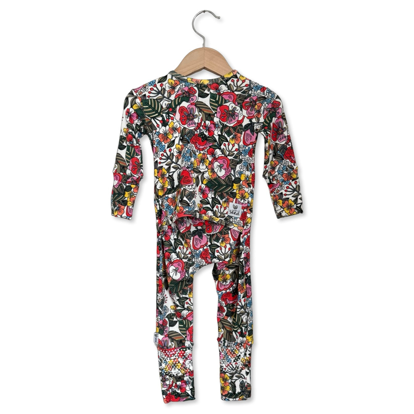 Children's floral patterned onesie on a hanger against a white background