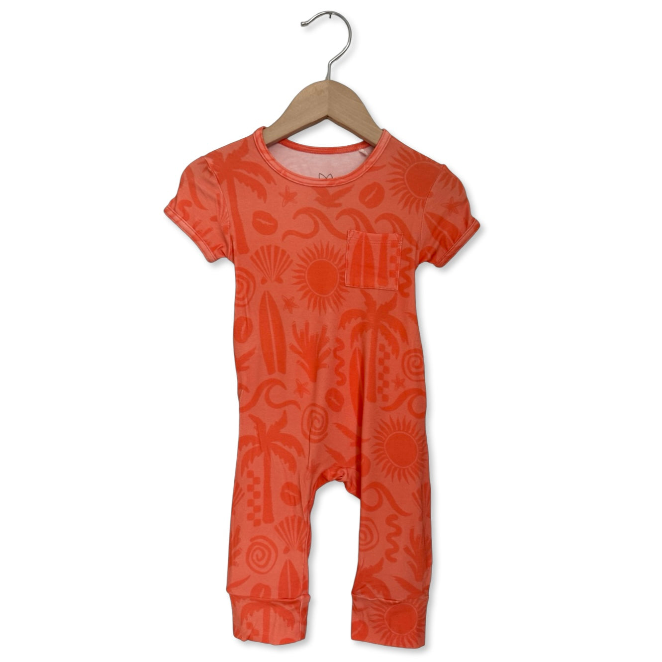 Orange patterned baby romper on a hanger against a white background