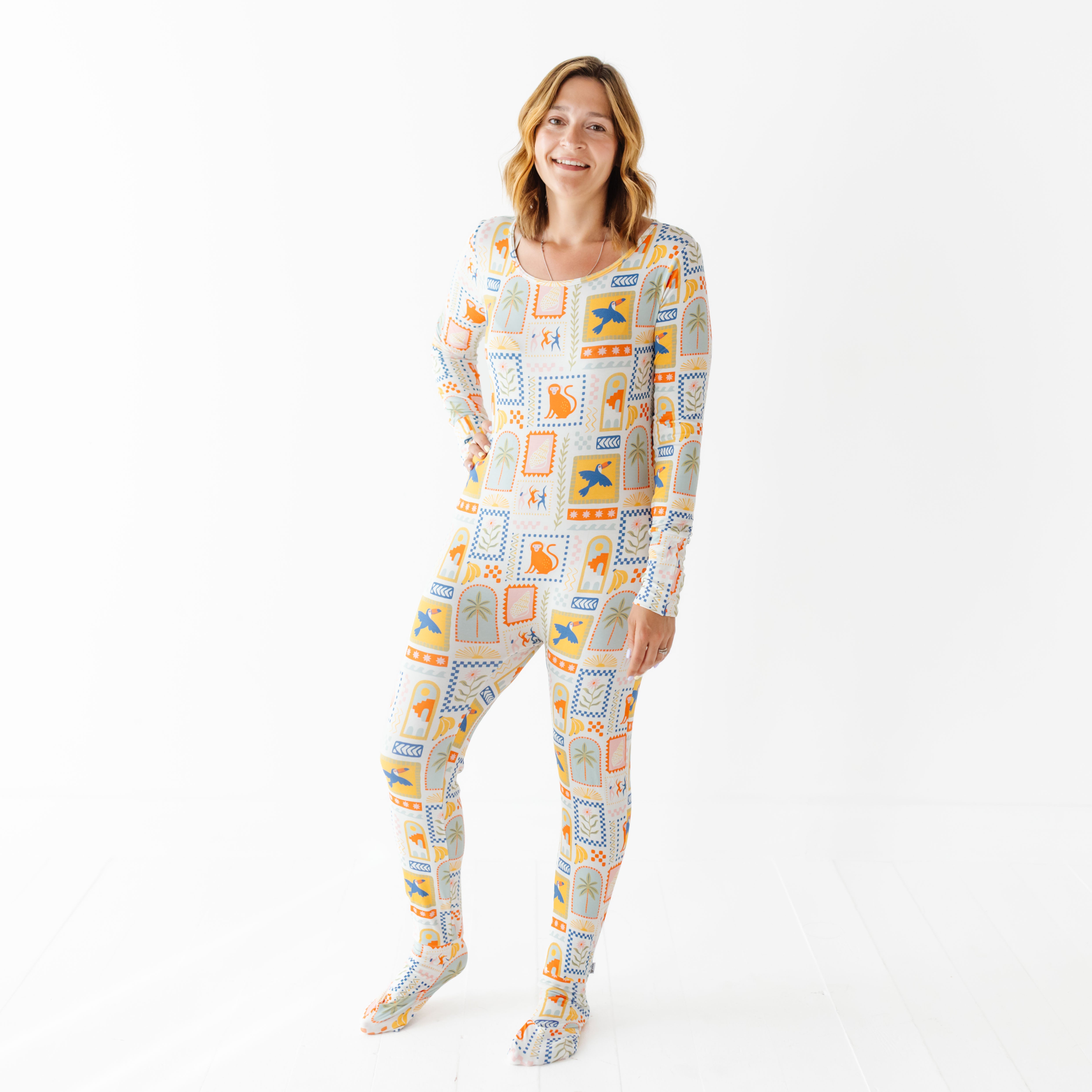 Woman wearing a patterned onesie on a white background