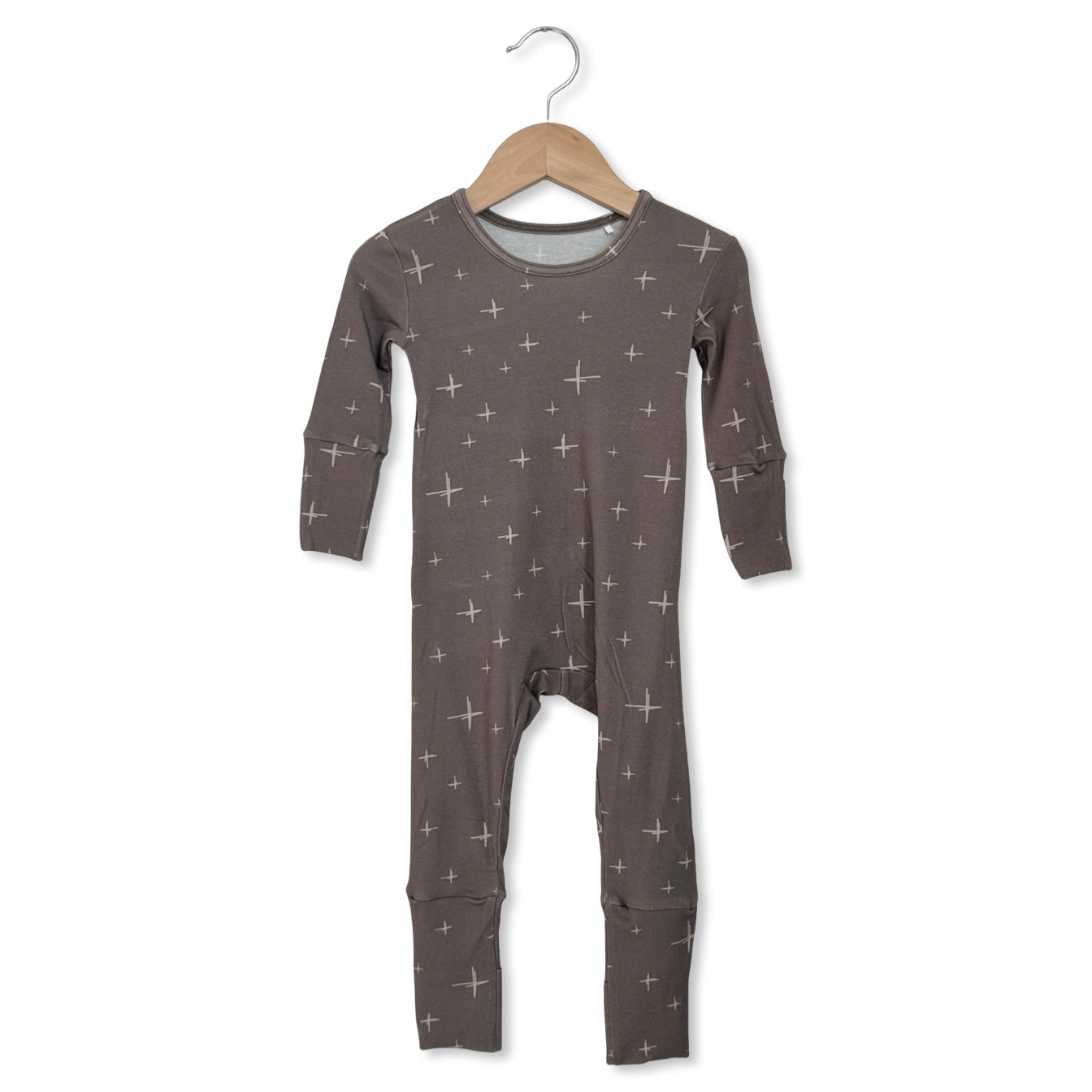 Children's gray onesie with star pattern on a hanger against a white background
