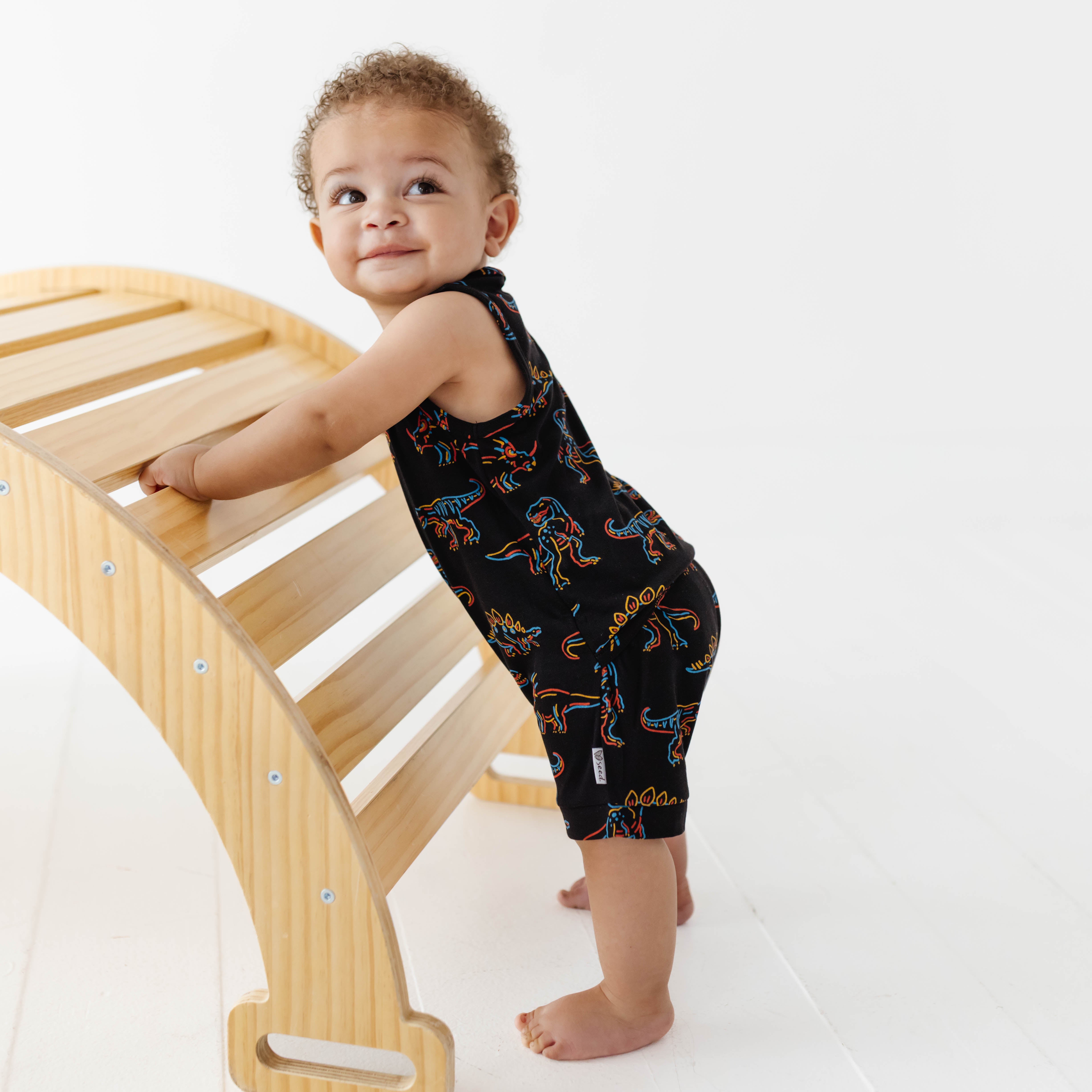 Child climbing a wooden ladder on a white background