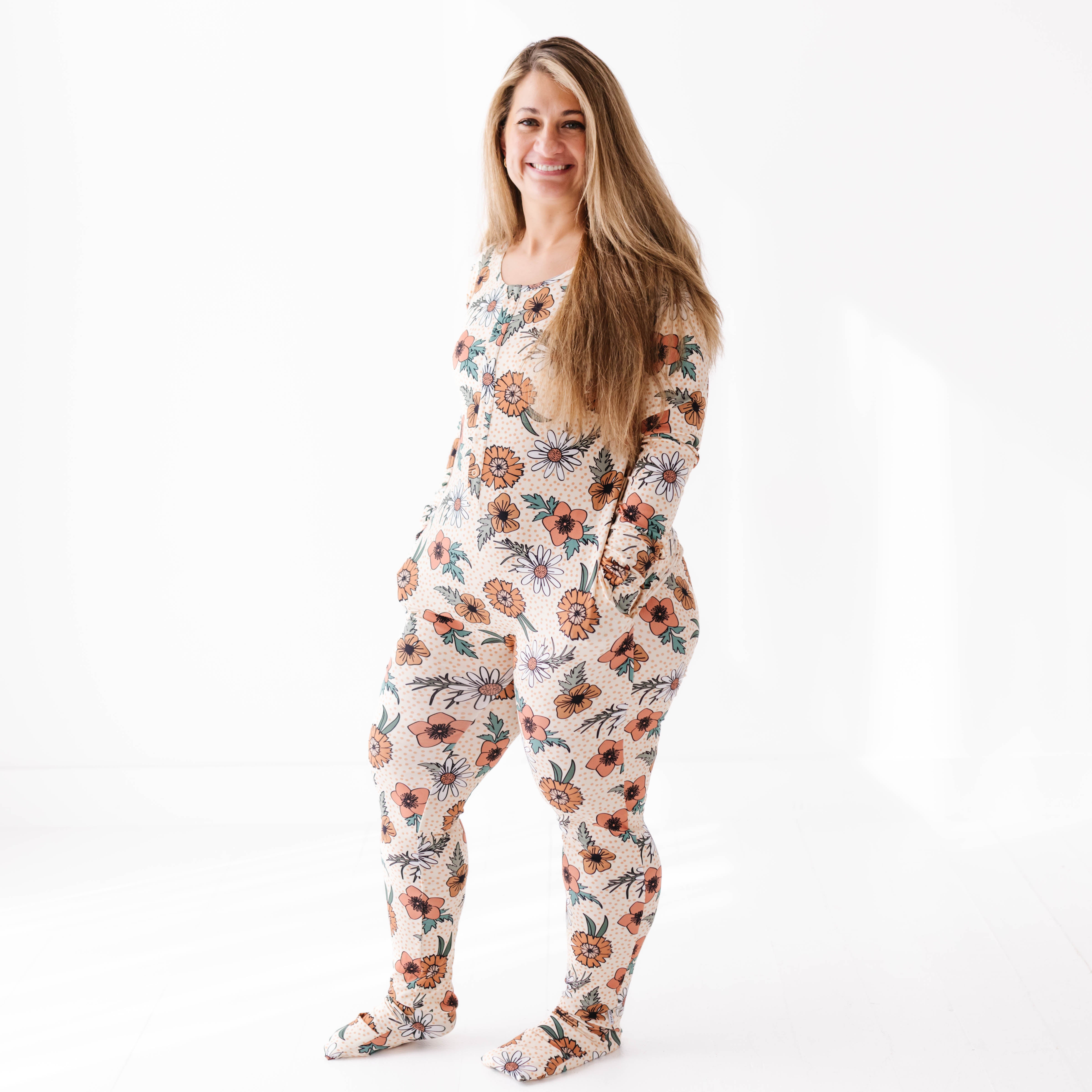 Woman wearing a floral onesie on a white background