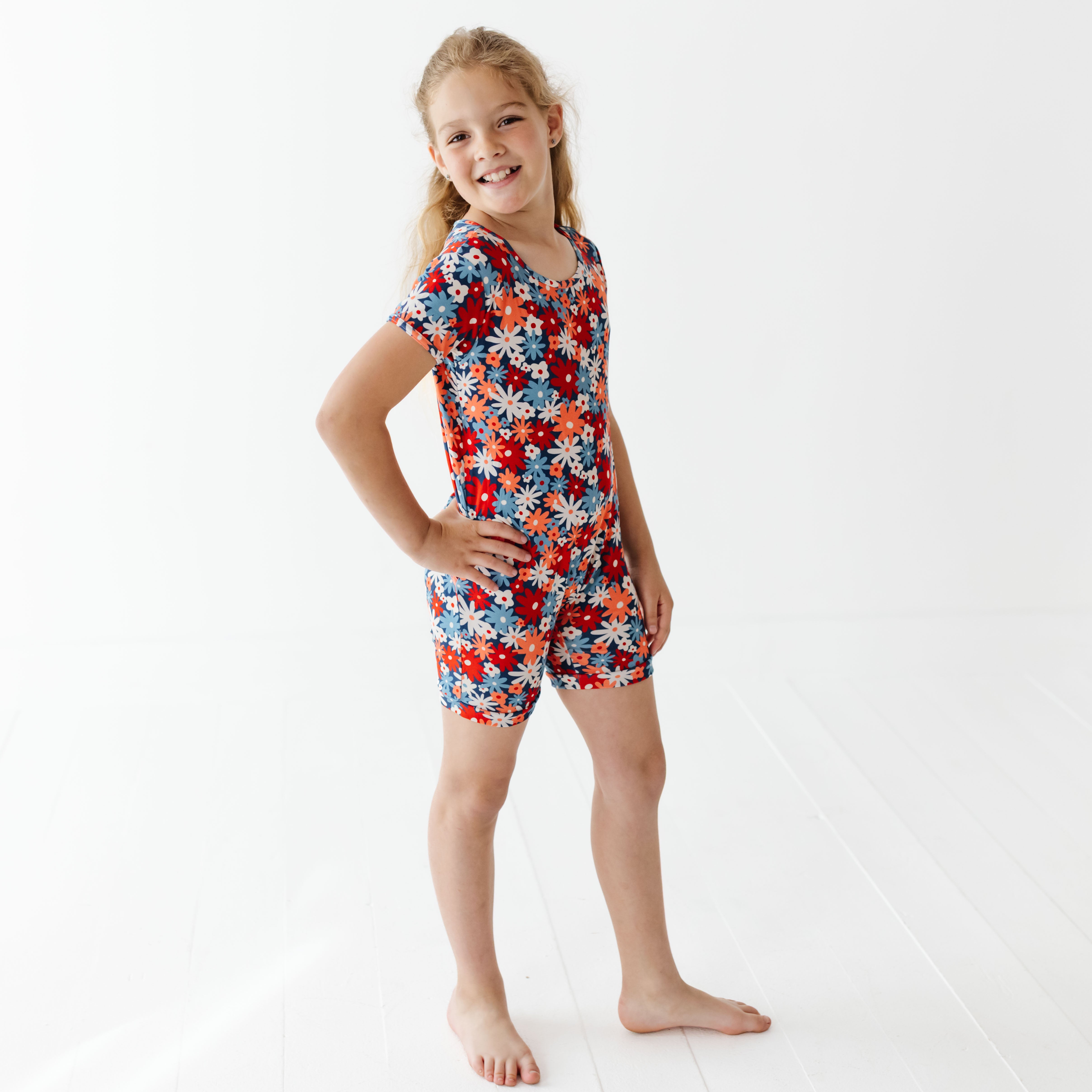 Child wearing colorful romper with whit background 