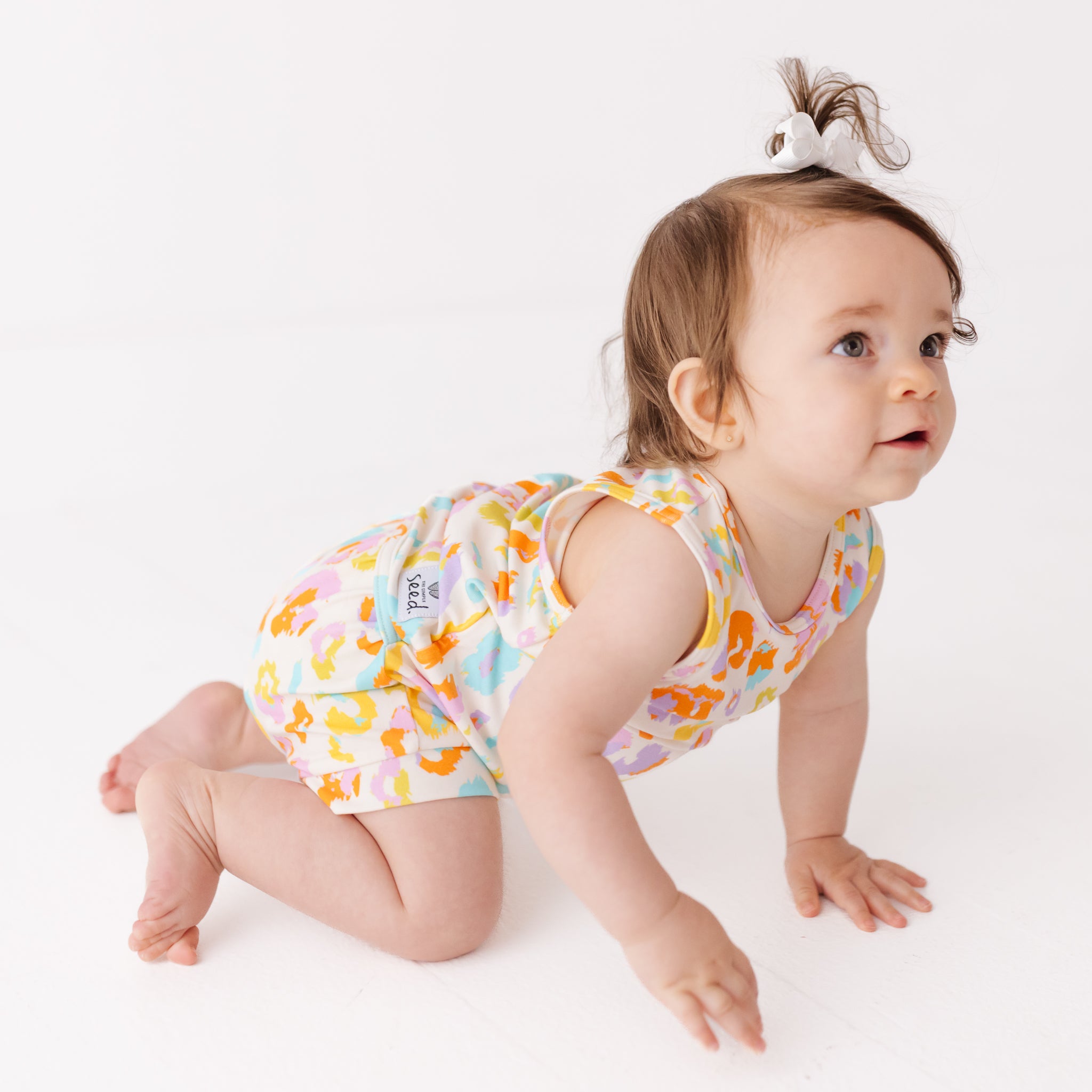 Baby in a colorful outfit on a white background