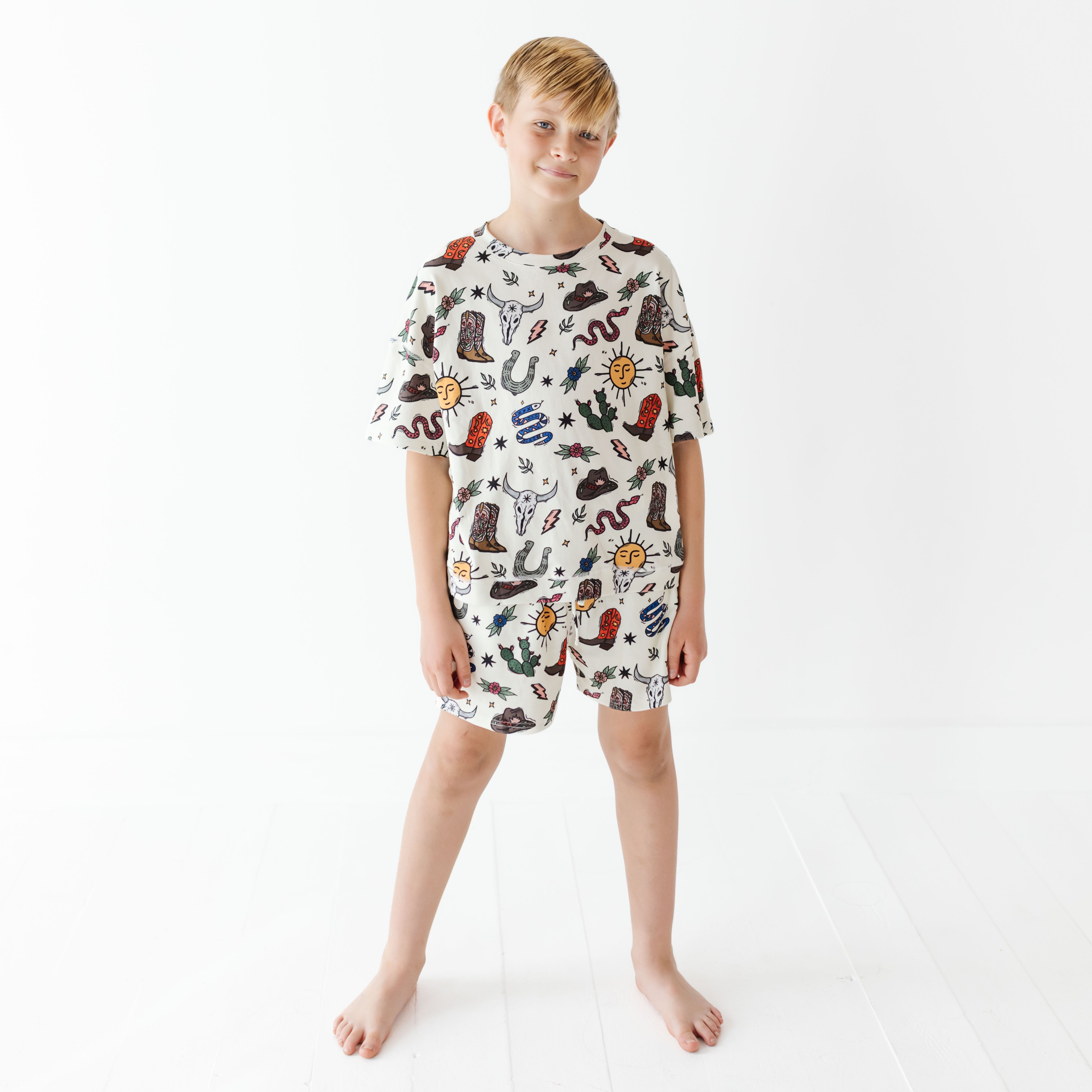 Child wearing a patterned outfit on a white background