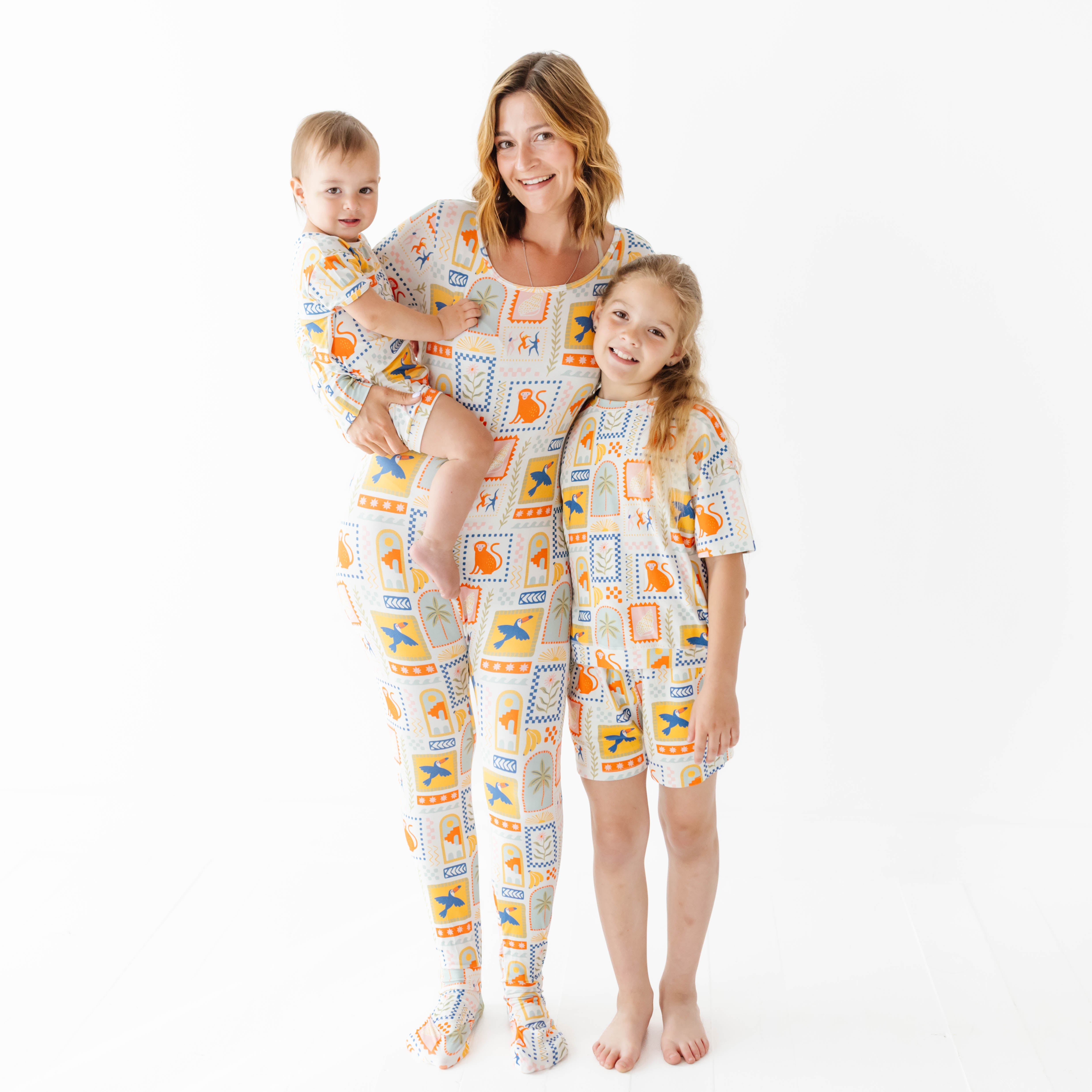 Woman and two children wearing matching sets with a pattern on a white background