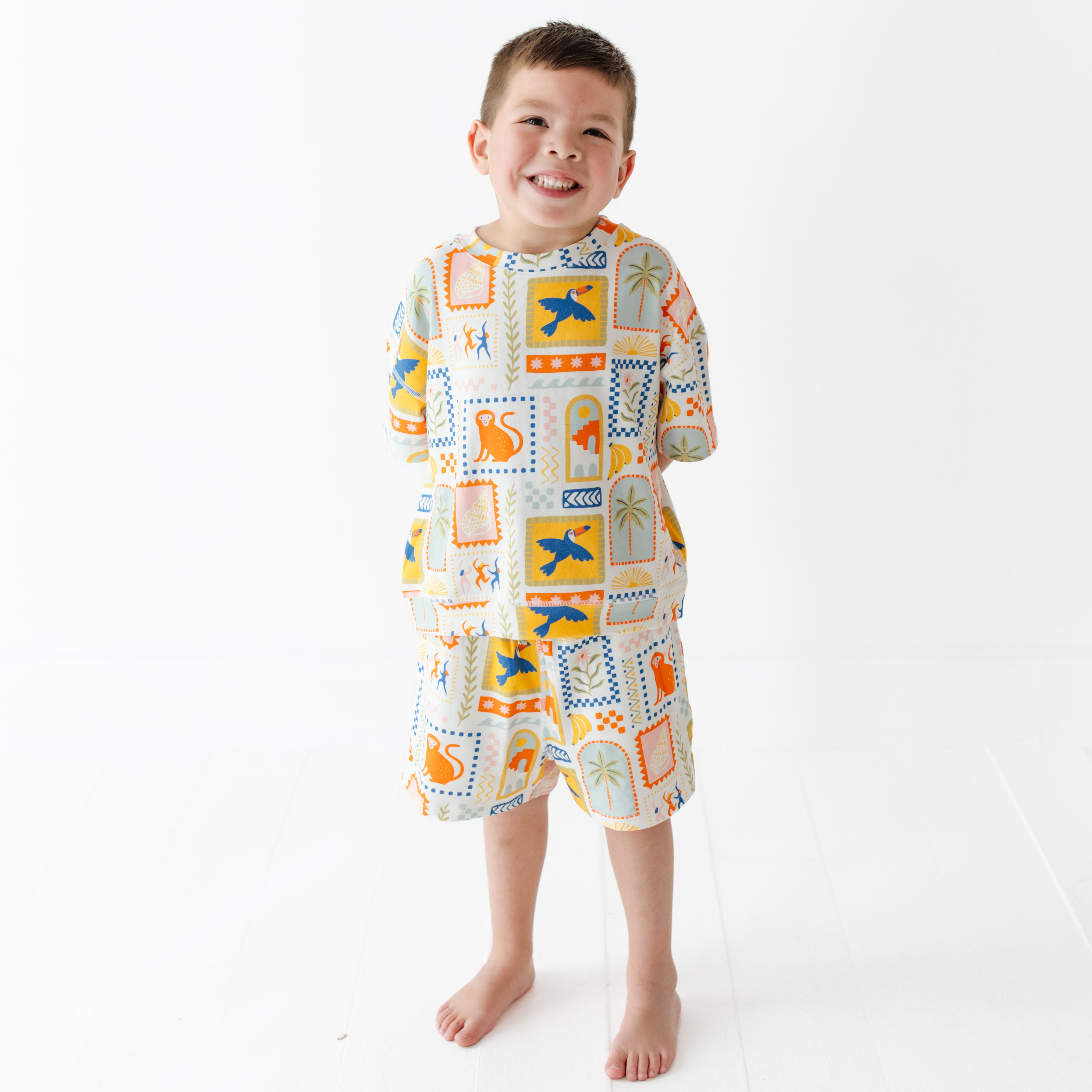 Child wearing a colorful sweat set with a pattern on a white background