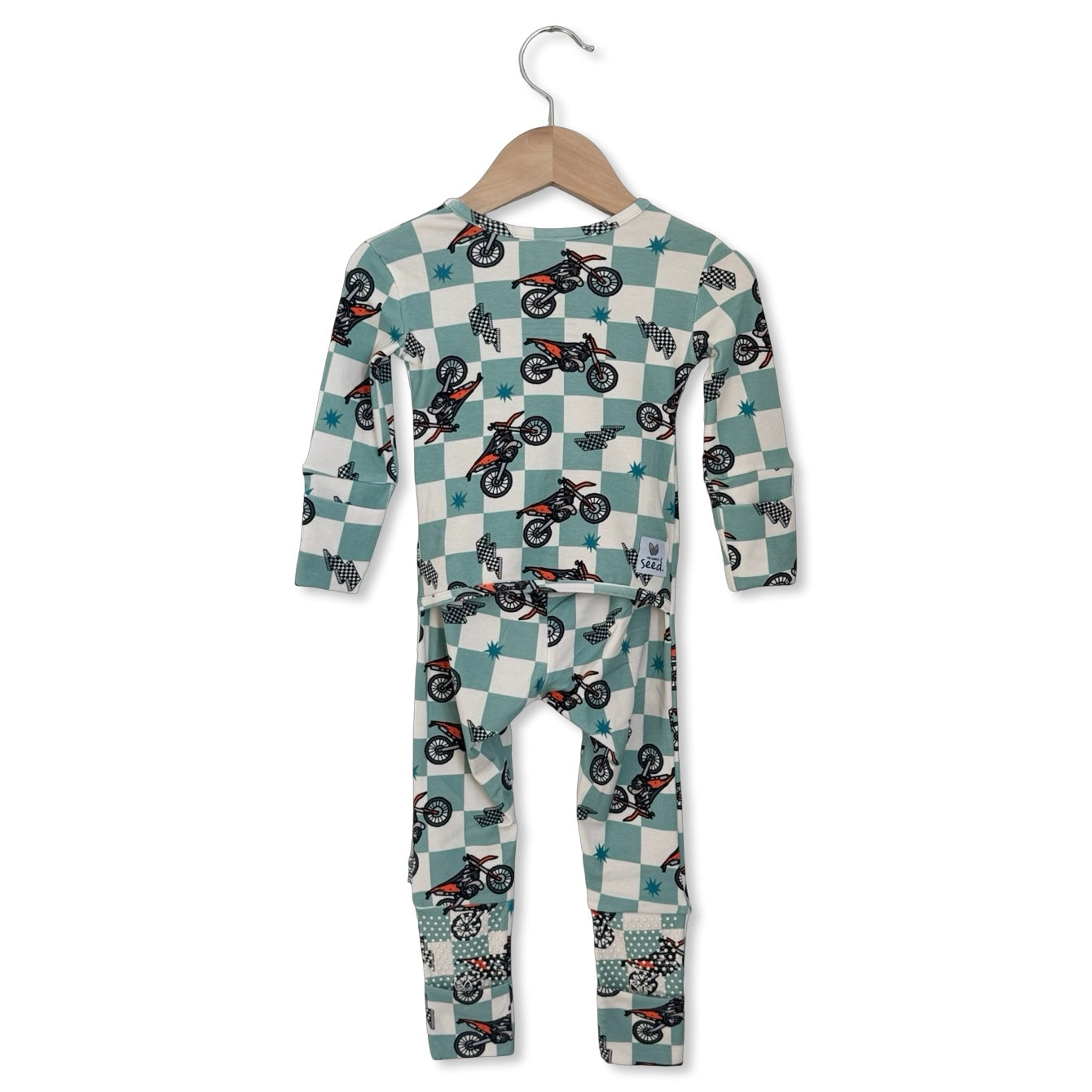 Children's pajama set with motorcycle pattern on a hanger against a white background