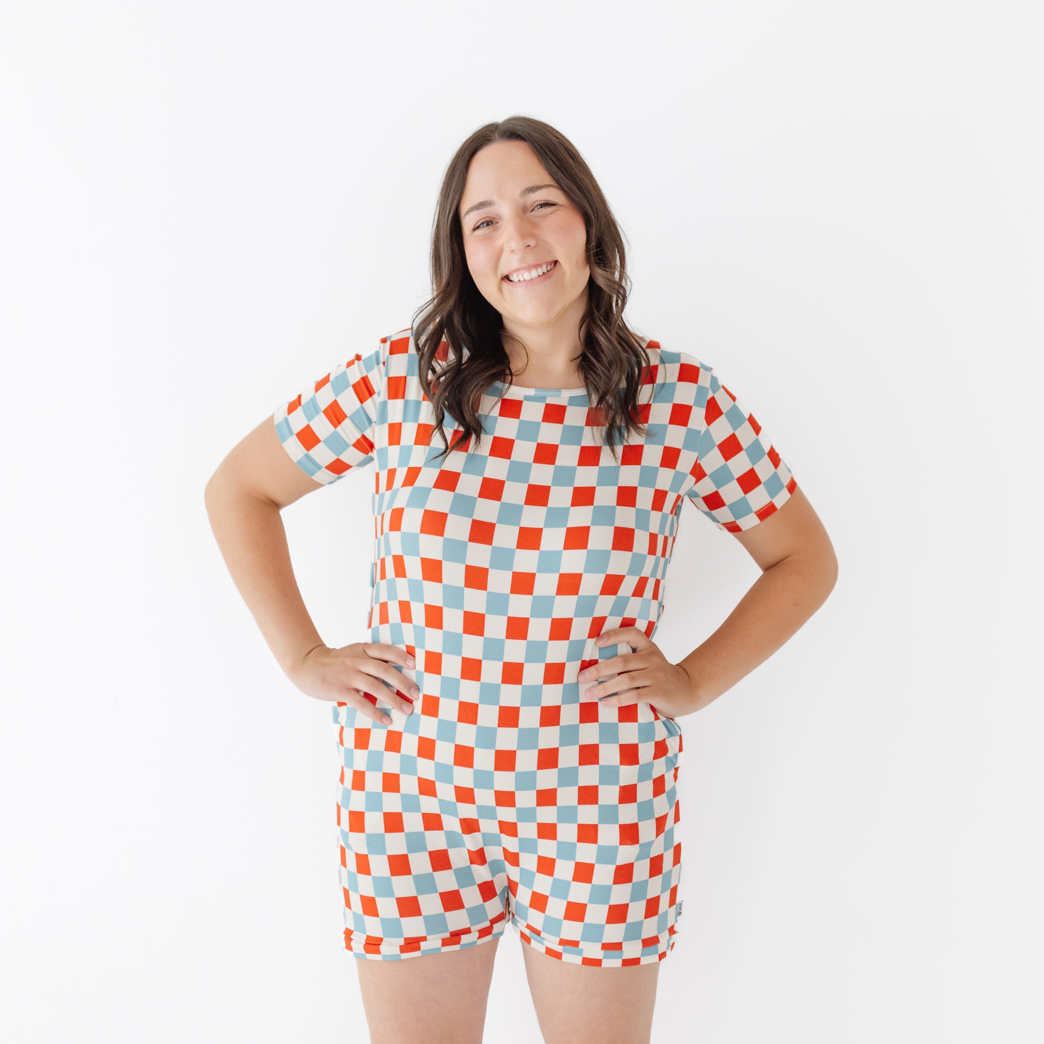 Woman wearing a red, white, and blue checkered outfit on a white background