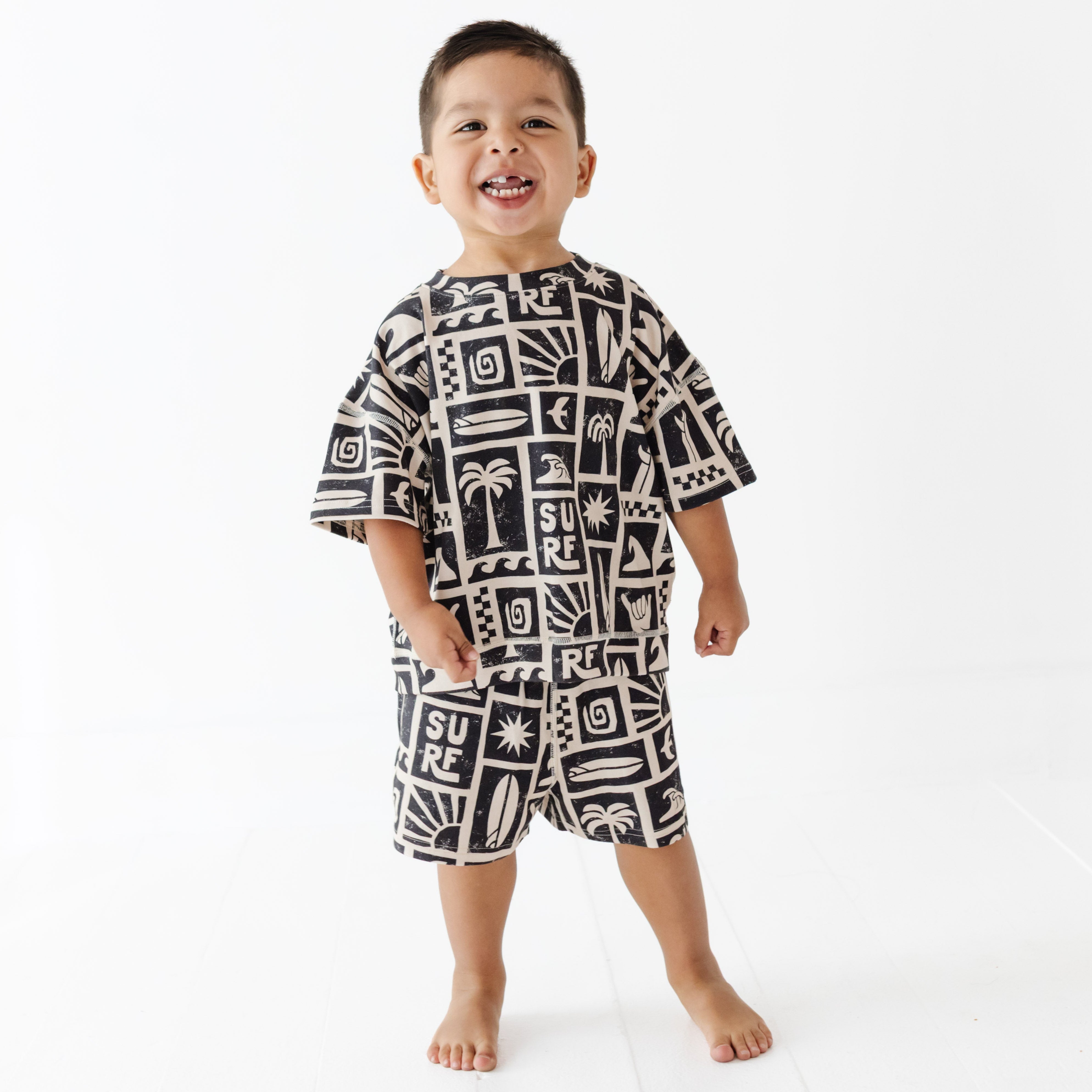 Child wearing a black and white patterned outfit on a white background