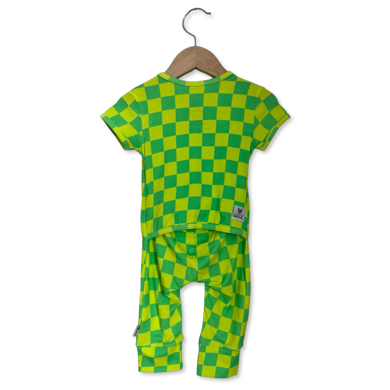 Green and yellow checkered outfit on a hanger against a white background