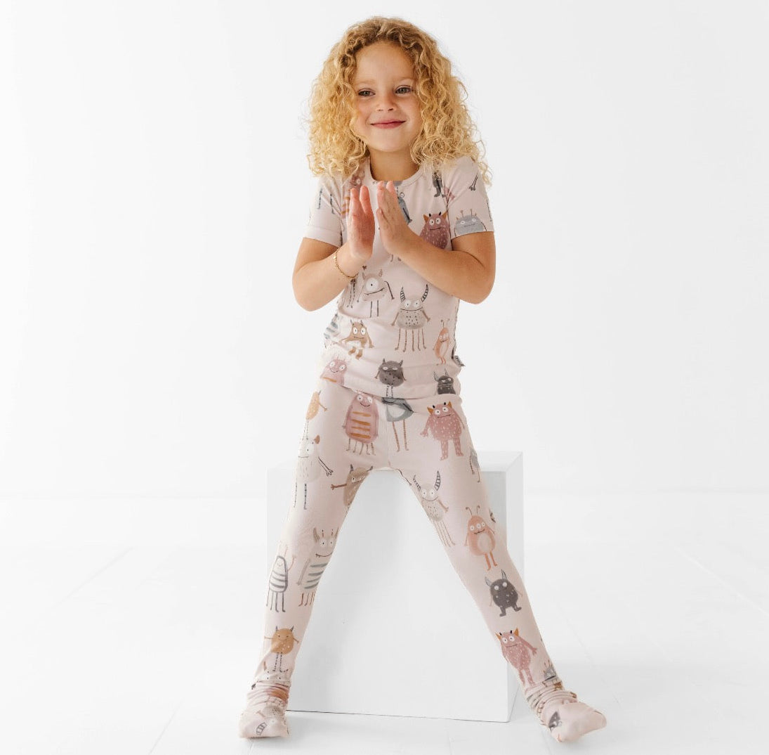Child wearing a patterned outfit on a white background