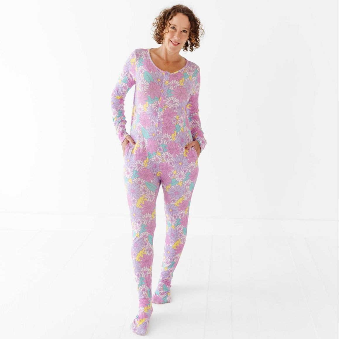 Woman wearing a floral onesie on a white background