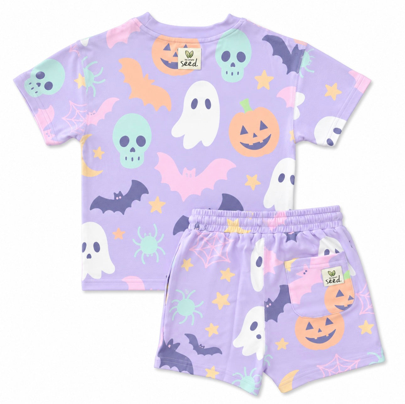 A children's two-piece pajama set featuring a short-sleeve top and matching shorts in light lavender purple, decorated with a colorful Halloween pattern of ghosts, pumpkins, bats, spiders, stars, and cobwebs. The brand name 'Sed.