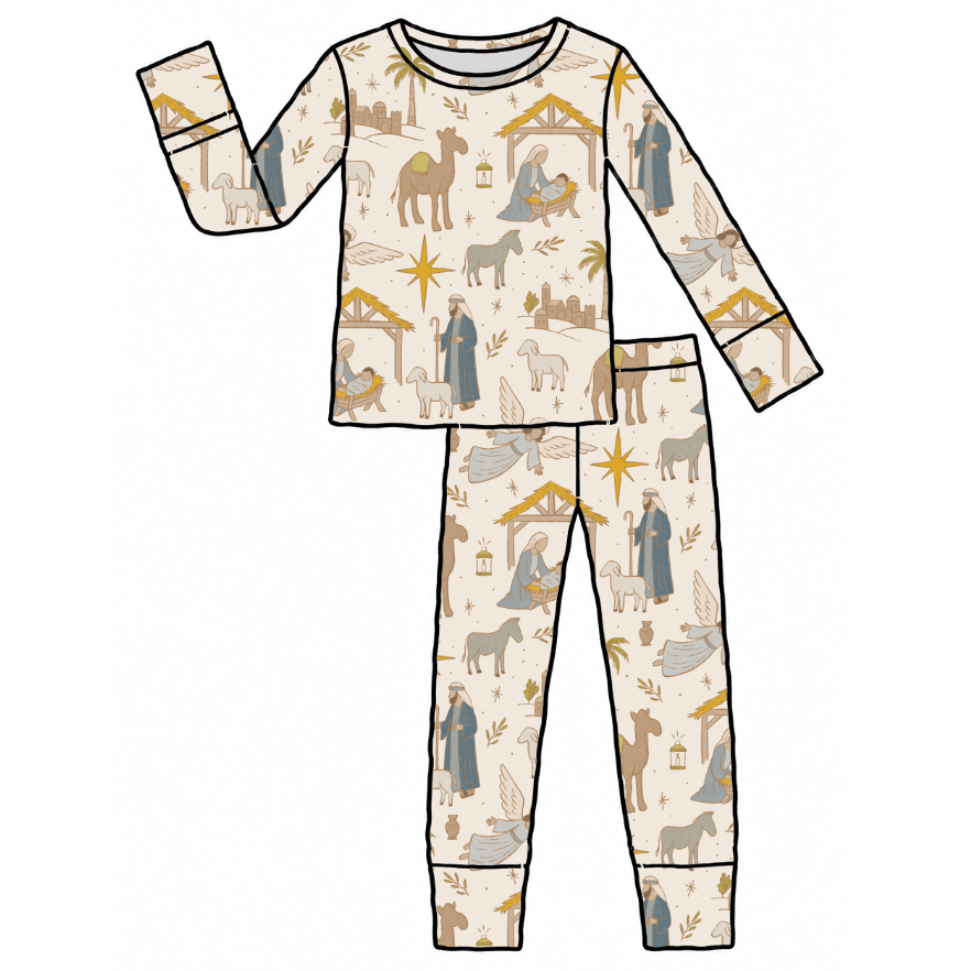 A flat-lay vector illustration of a two-piece children's pajama set featuring a Christmas nativity scene print on a cream background with black outlines.