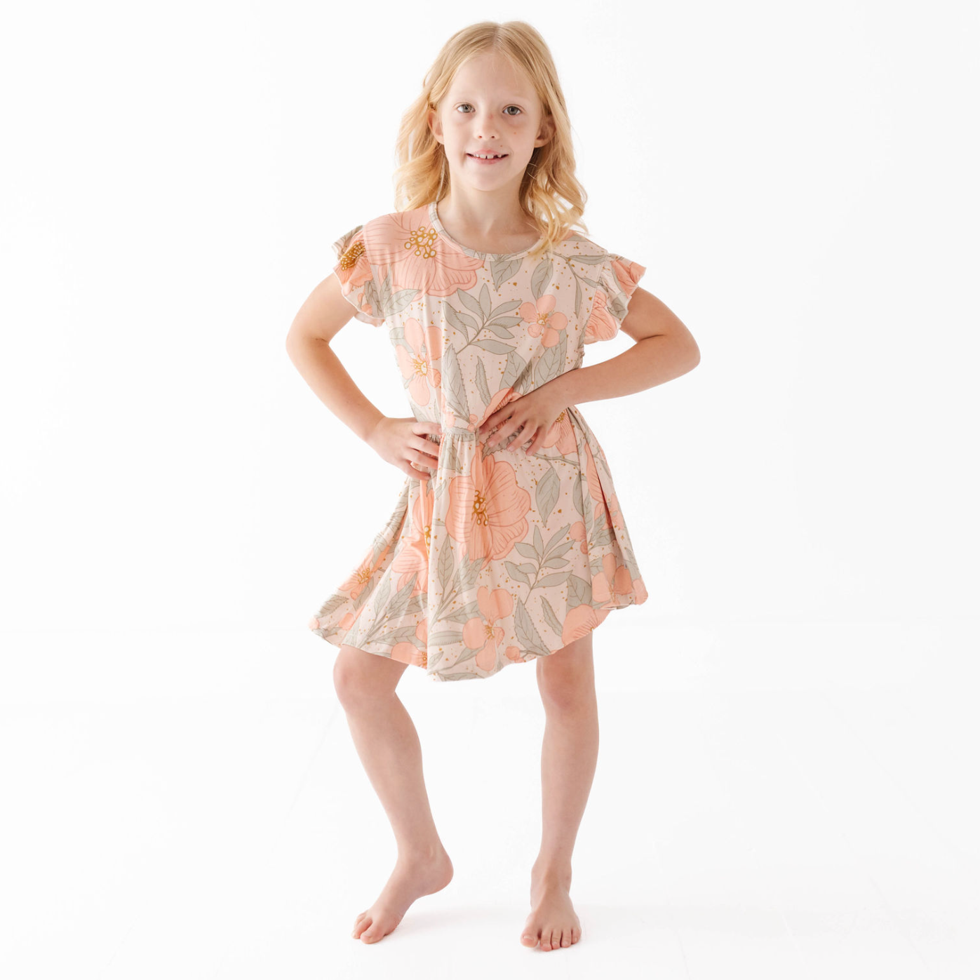 Young girl wearing a floral dress on a white background