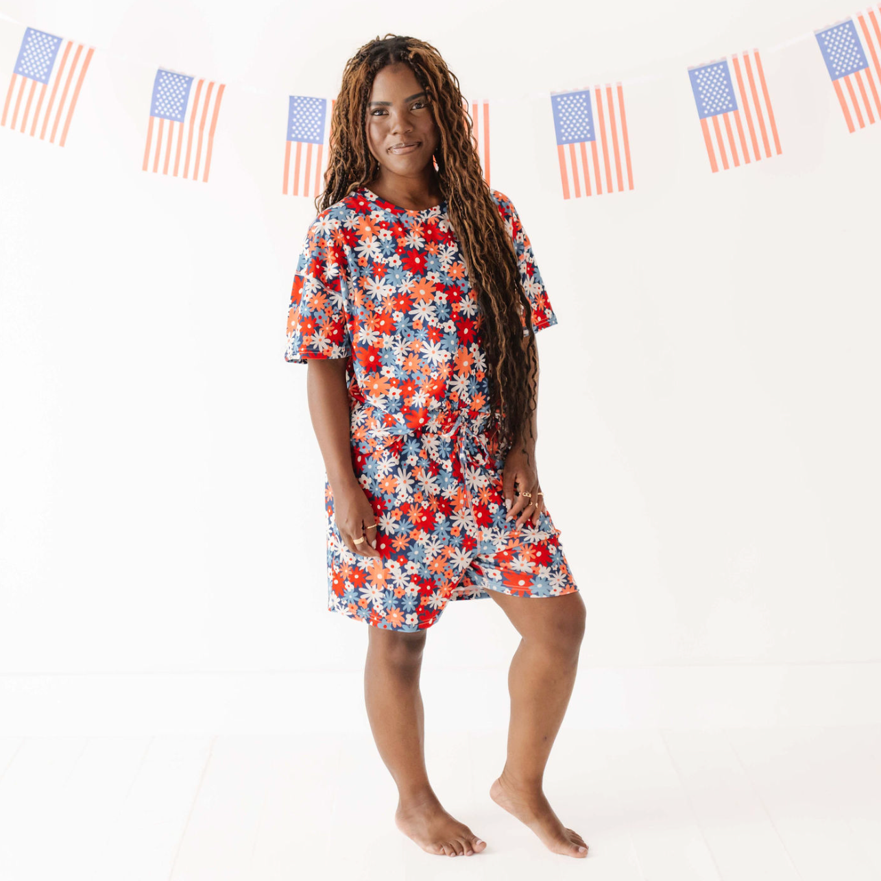 Woman wearing a floral dress with American flag decorations in the background