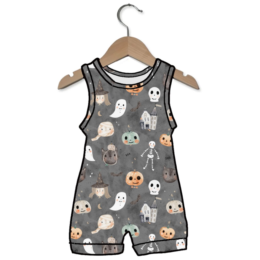A sleeveless baby romper with a gray background and a cute Halloween print featuring ghosts, skeletons, pumpkins, and haunted houses, hanging on a wooden hanger against a white background.