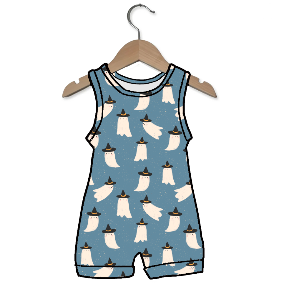 A baby romper in dusty blue with a repeating pattern of white ghosts wearing black hats, hanging on a wooden hanger against a plain white background.