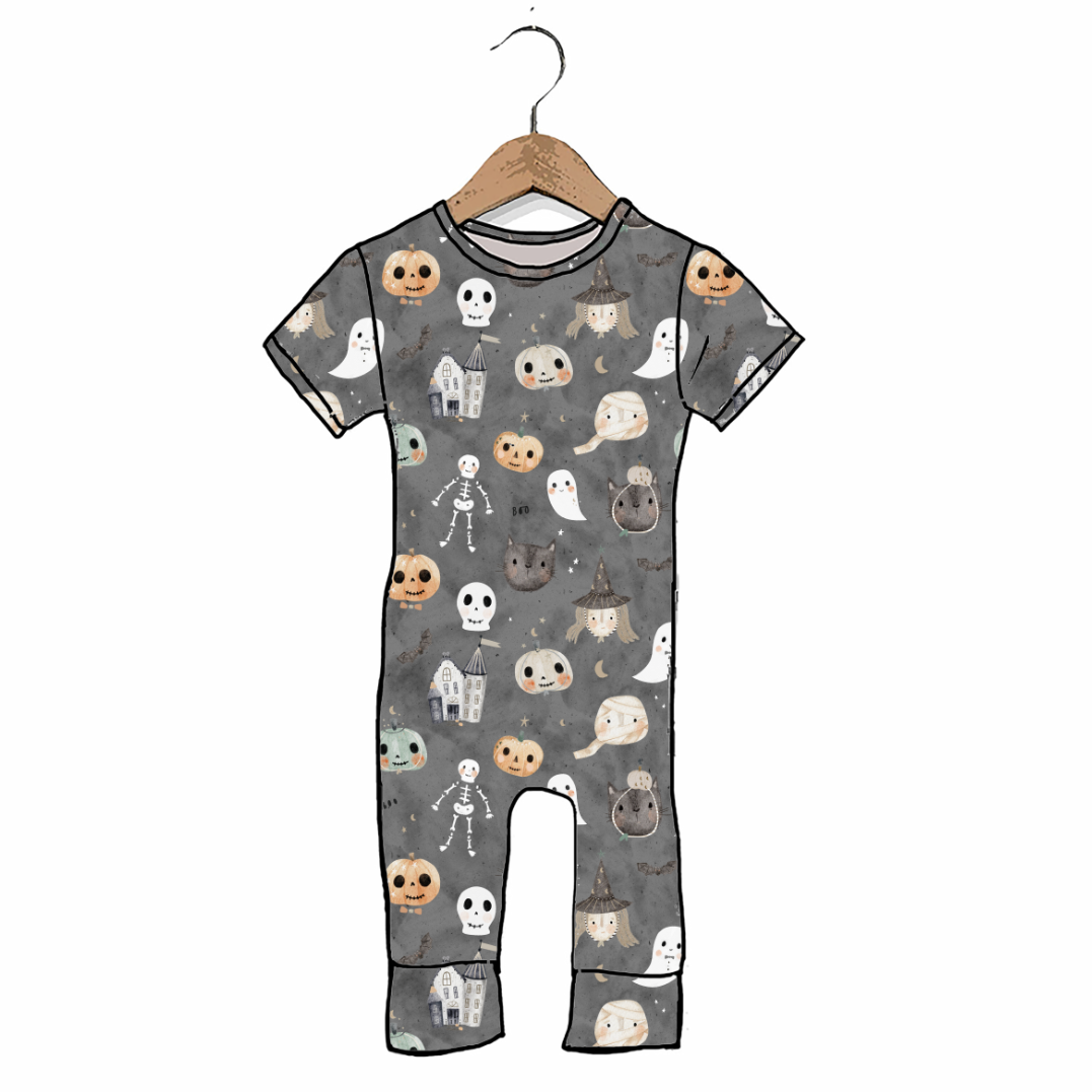 A baby short-sleeve one-piece romper with an all-over Halloween print, hanging on a wooden hanger against a plain white background.