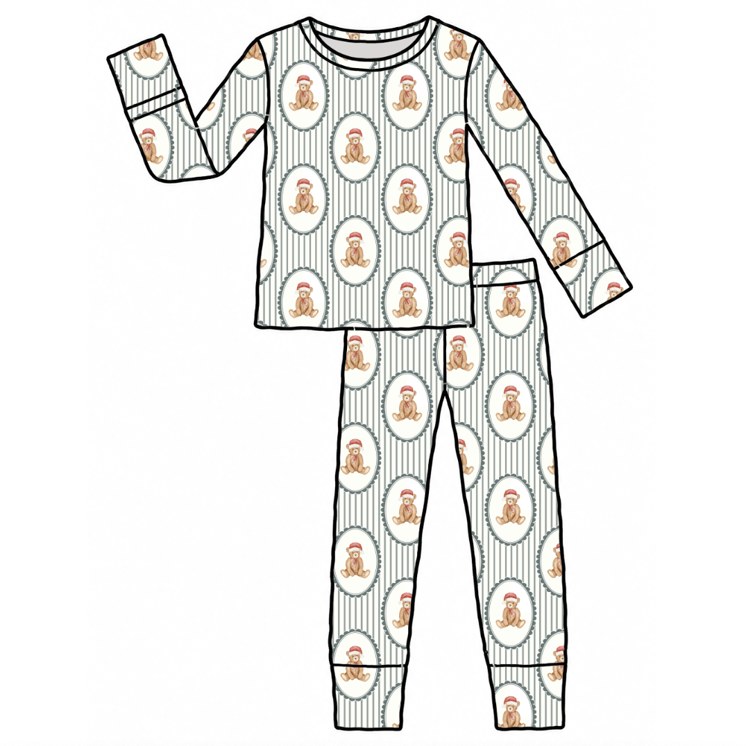A flat line-art illustration of a two-piece pajama set on a plain white background. The set includes a long-sleeve top and matching pants with a repeating pattern of white oval medallions containing small orange cartoon figures, over a light gray pinstripe base.