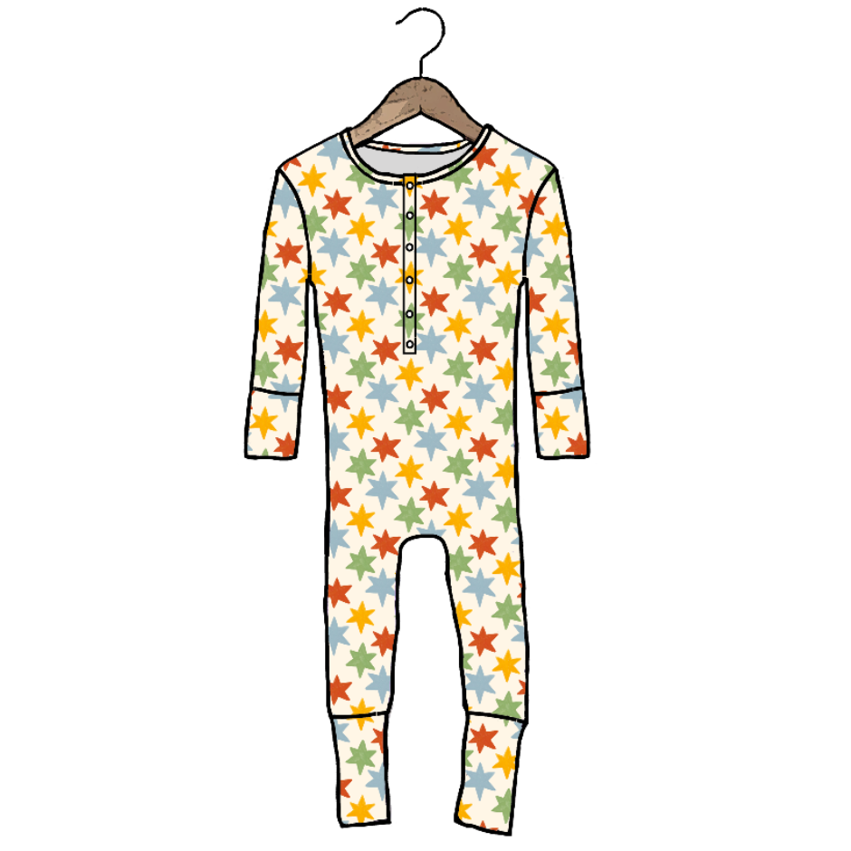 A long-sleeve baby jumpsuit with a colorful star pattern, shown hanging on a wooden hanger against a plain white background.