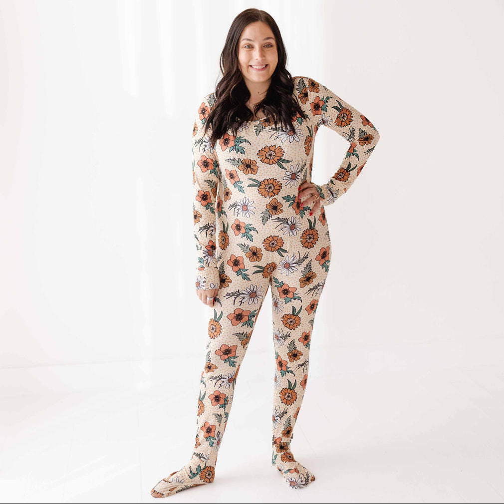 Woman wearing a floral onesie against a white background