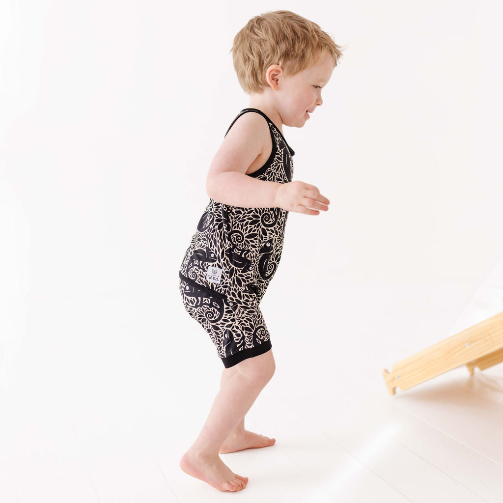 Child wearing a black and white patterned outfit on a white background