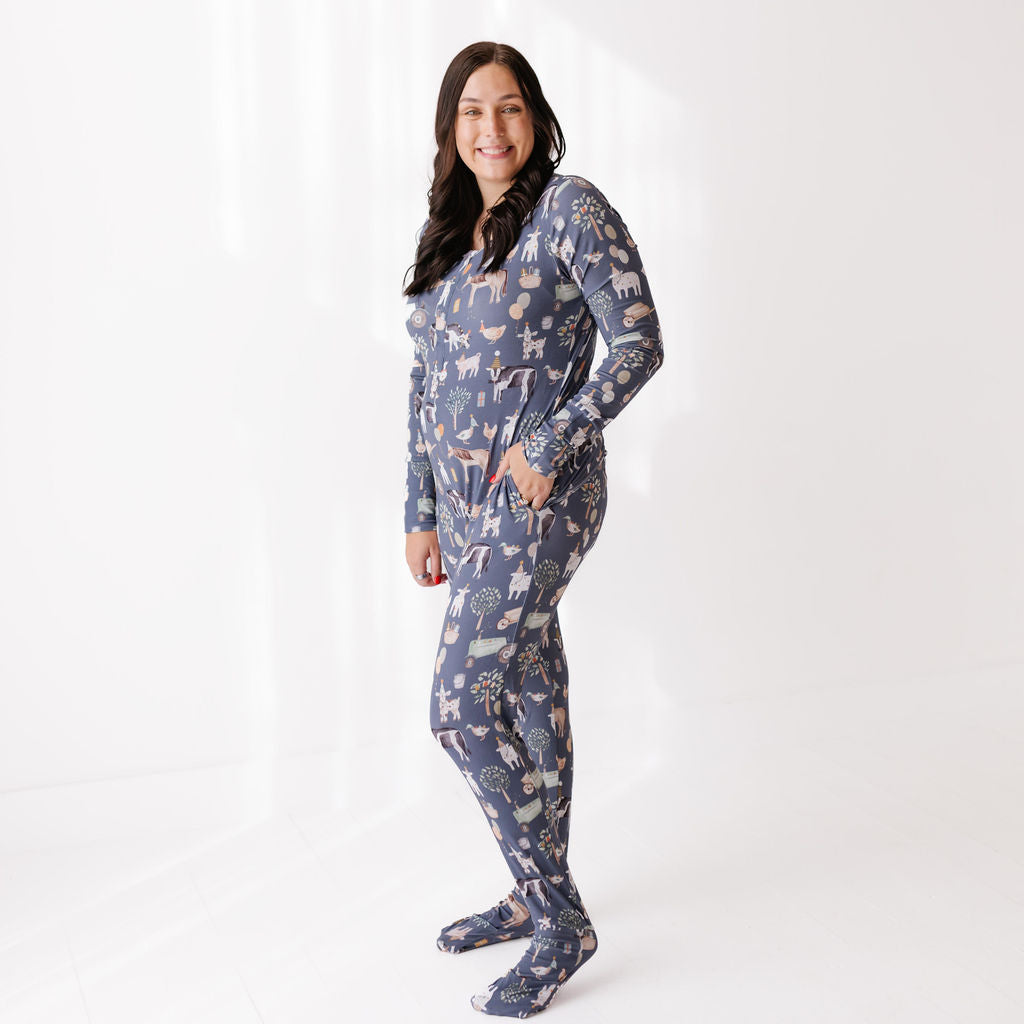 Woman wearing a blue animal-patterned onesie on a white background