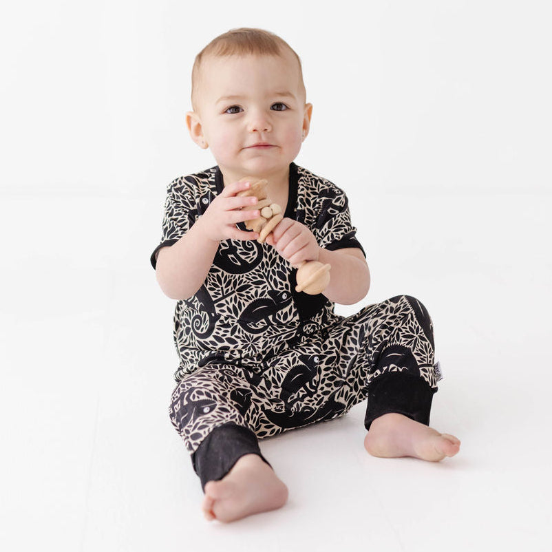 Baby wearing a black and white patterned outfit on a white background