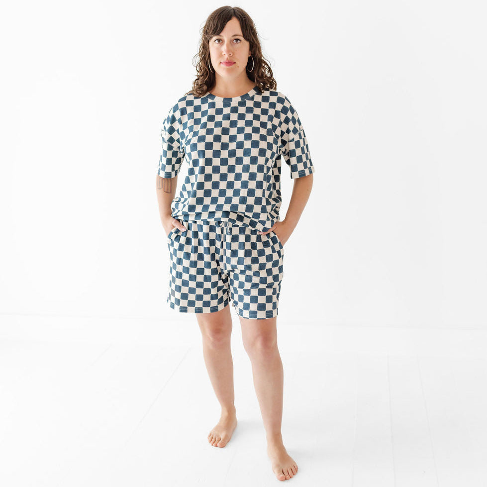 Woman wearing a checkered outfit on a white background