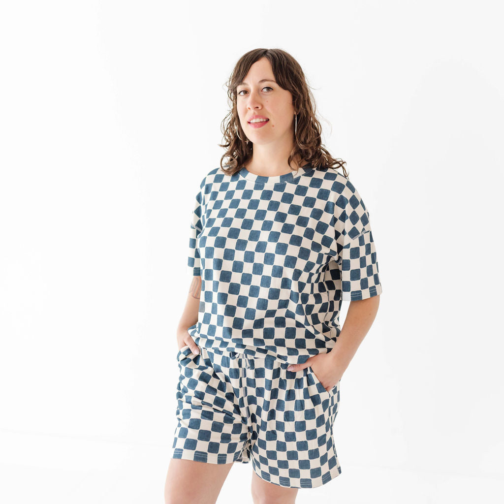 Woman wearing a blue and white checkered outfit on a white background
