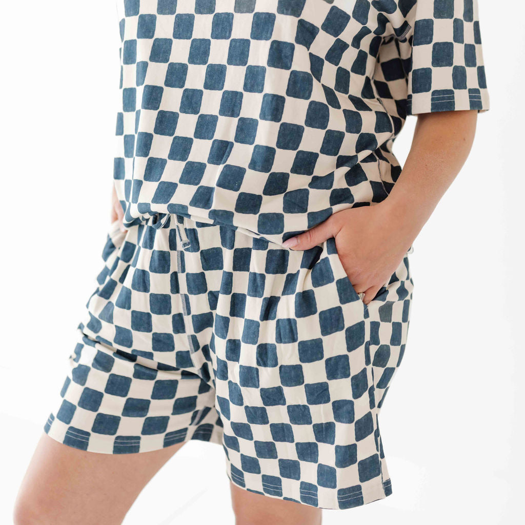 Person wearing a blue and white checkered outfit on a white background