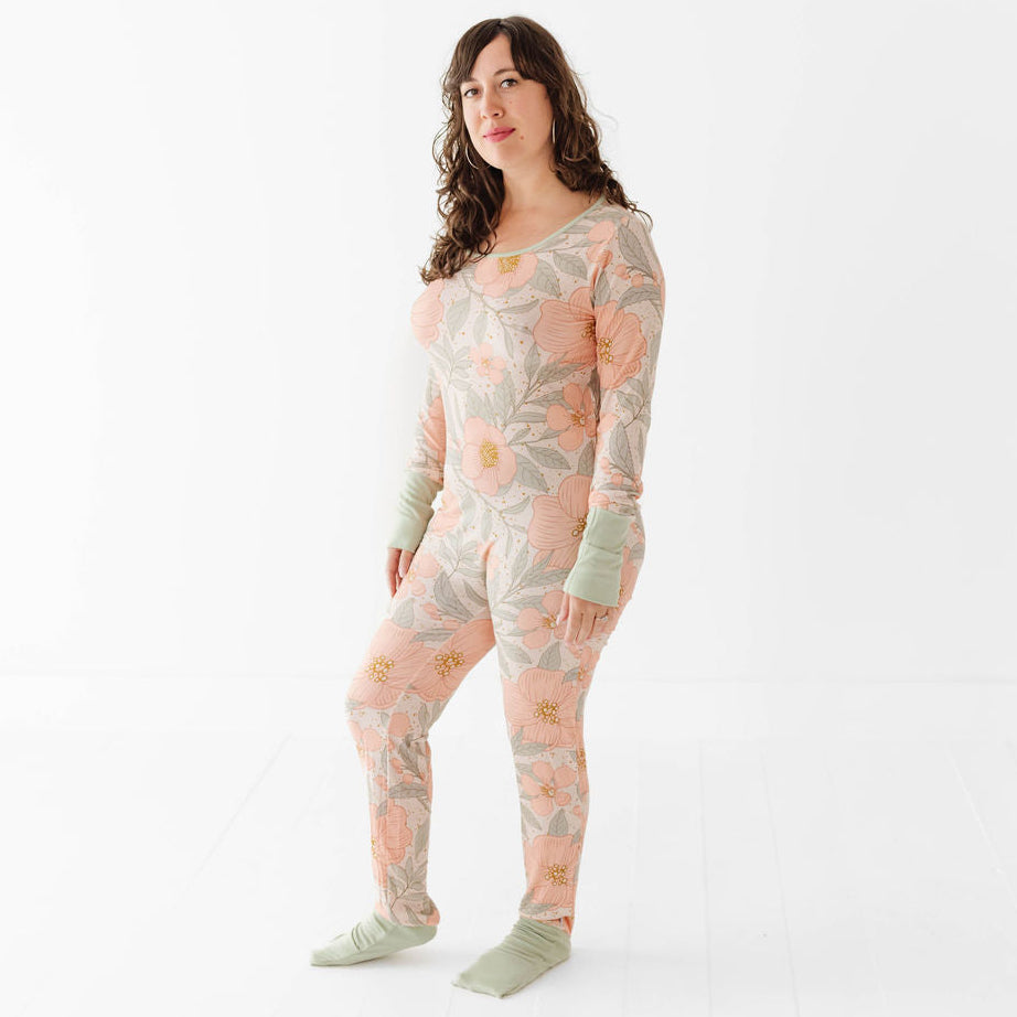 Woman wearing a floral patterned onesie on a white background