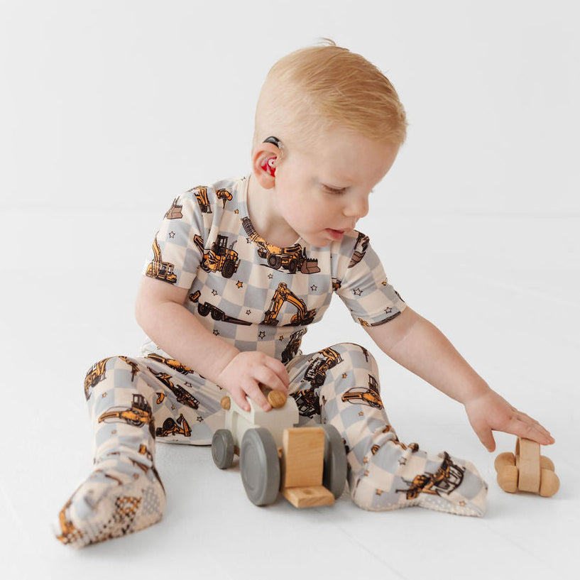 Child playing with wooden toys on a white background